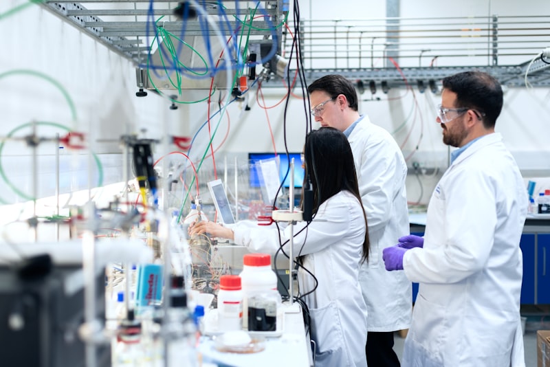 Laboratory staff in white coats at work